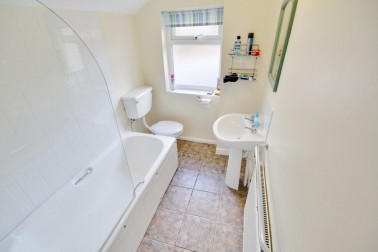 Shiny white first floor bathroom (2); bath with thermostatic shower over, basin & loo